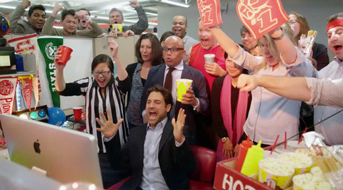 A group of people cheering

Description automatically generated